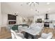 A great open living space flows from the fireplace to the dining area and into the kitchen with modern appliances at 1803 Eagle Village Ave, Henderson, NV 89012