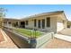 Fenced backyard with a covered patio and artificial grass, offering a private and comfortable outdoor area at 2040 Tucuman Ave, Pahrump, NV 89048