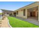 Backyard featuring an artificial grass lawn, patio, and gravel area, creating a low-maintenance outdoor space at 2040 Tucuman Ave, Pahrump, NV 89048