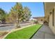 Backyard featuring artificial turf, gravel, and a covered patio area, creating a versatile outdoor space at 2040 Tucuman Ave, Pahrump, NV 89048