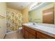 Bathroom with a single vanity sink, floral shower curtain, and tiled floor at 2040 Tucuman Ave, Pahrump, NV 89048