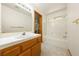 Bright bathroom featuring a tub/shower combination and a vanity with a tiled countertop and wooden cabinets at 2040 Tucuman Ave, Pahrump, NV 89048