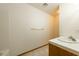Bathroom with a tiled shower stall, tile flooring, a sink with wooden cabinets, and a neutral color scheme at 2040 Tucuman Ave, Pahrump, NV 89048