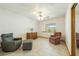 Bedroom featuring tiled floor, chairs and ottoman, ceiling fan and a large window at 2040 Tucuman Ave, Pahrump, NV 89048