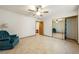 Bedroom featuring mirrored closet doors, ceiling fan, and tiled floor at 2040 Tucuman Ave, Pahrump, NV 89048