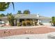 Well-maintained one-story home with desert landscaping, mature trees, and a tile roof at 2040 Tucuman Ave, Pahrump, NV 89048