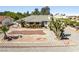 An expansive view of a single story home with desert landscaping and a unique gravel driveway at 2040 Tucuman Ave, Pahrump, NV 89048
