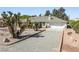 Lovely home with desert landscaping and a well-maintained front yard and driveway at 2040 Tucuman Ave, Pahrump, NV 89048