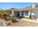 Home featuring a covered front porch and desert landscaping, including gravel and various plants at 2040 Tucuman Ave, Pahrump, NV 89048