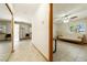Hallway view with tiled flooring connects the rooms, offering a glimpse into the bedroom at 2040 Tucuman Ave, Pahrump, NV 89048