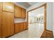 Hallway featuring wood cabinets and an open doorway leading to a bright room with large windows and a backyard view at 2040 Tucuman Ave, Pahrump, NV 89048