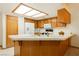 Bright kitchen featuring wood cabinets, tiled countertop, and modern appliances providing ample counter space at 2040 Tucuman Ave, Pahrump, NV 89048