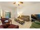 Spacious living room with tile flooring, comfortable furniture, and a view of the front yard at 2040 Tucuman Ave, Pahrump, NV 89048