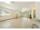 Spacious living room with tray ceilings, tile flooring, large windows, and open doors leading to the backyard at 2040 Tucuman Ave, Pahrump, NV 89048