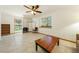 Open living room with natural light, tiled flooring, and an access door to the backyard seating area at 2040 Tucuman Ave, Pahrump, NV 89048