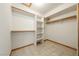 A spacious walk-in closet with built-in shelving and wooden closet rods for optimal storage at 2040 Tucuman Ave, Pahrump, NV 89048