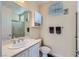 Neutral bathroom with a single sink vanity, medicine cabinet, and walk-in shower at 2116 Burtonsville Dr, Henderson, NV 89044