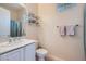Bright bathroom with a single sink vanity, towel rack, and toilet at 2116 Burtonsville Dr, Henderson, NV 89044
