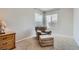 Comfortable bedroom featuring neutral carpet, reading chair and ample natural light at 2116 Burtonsville Dr, Henderson, NV 89044