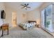 Carpeted bedroom featuring TV and access to bathroom and backyard through french doors at 2116 Burtonsville Dr, Henderson, NV 89044