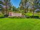 Inviting community entrance with a manicured lawn, beautiful flowers and stone signage at 2116 Burtonsville Dr, Henderson, NV 89044