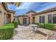 Courtyard with a table, chairs, manicured landscaping, and a walkway at 2116 Burtonsville Dr, Henderson, NV 89044