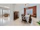 Elegant dining room featuring a crystal chandelier, wainscoting and tile floors at 2116 Burtonsville Dr, Henderson, NV 89044
