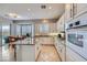 Bright, open kitchen with white cabinets, granite counters, and stainless steel appliances at 2116 Burtonsville Dr, Henderson, NV 89044