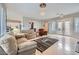 Comfortable living room with sofas, tile floors, lots of lighting and access to other rooms at 2116 Burtonsville Dr, Henderson, NV 89044