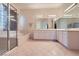 Luxurious bathroom with glass enclosed shower, soaking tub, double sink vanity, and tile flooring at 2116 Burtonsville Dr, Henderson, NV 89044