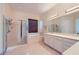 Bright bathroom with glass enclosed shower, soaking tub, double sink vanity, and tile flooring at 2116 Burtonsville Dr, Henderson, NV 89044