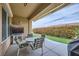 Relaxing covered patio with outdoor seating, TV, and manicured landscaping at 2116 Burtonsville Dr, Henderson, NV 89044