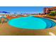 A large, resort-style swimming pool with ample seating and umbrellas for a relaxing outdoor experience at 2116 Burtonsville Dr, Henderson, NV 89044