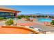 Large community swimming pool with lounge chairs, tables, and mountain views on the horizon at 2116 Burtonsville Dr, Henderson, NV 89044