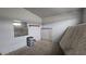 Well-lit bedroom featuring carpeted flooring and minimalist decor at 2125 Flower Ave, North Las Vegas, NV 89030