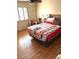 Bedroom with hardwood floors, plush bedding and lots of natural light at 2569 Malabar Ave, Las Vegas, NV 89121