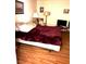 Cozy bedroom featuring hard wood floors, warm lighting and neutral colored walls at 2569 Malabar Ave, Las Vegas, NV 89121