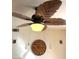 A unique ceiling fan with leaf-shaped blades above a clock creates a stylish ambiance at 2569 Malabar Ave, Las Vegas, NV 89121