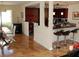 Open-concept dining room and kitchen layout with modern seating, stylish lighting, and hardwood floors at 2569 Malabar Ave, Las Vegas, NV 89121