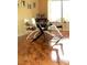 Bright dining room with modern glass table, hardwood floors, and natural light from large windows at 2569 Malabar Ave, Las Vegas, NV 89121