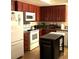 Functional kitchen with ample cabinetry, white appliances, and a portable kitchen island at 2569 Malabar Ave, Las Vegas, NV 89121