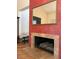 Living room featuring a stone fireplace with wooden logs and decorative mirror above at 2569 Malabar Ave, Las Vegas, NV 89121