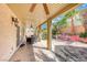 Covered patio with ceiling fan and lush backyard landscaping with multiple seating areas at 2853 Blythswood Sq, Henderson, NV 89044