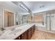 This bright bathroom offers dual sinks, a soaking tub, and a glass-enclosed shower, ideal for relaxation and convenience at 2853 Blythswood Sq, Henderson, NV 89044