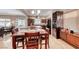 Spacious dining area with a wooden table, wine storage, and seamless access to the kitchen and living room at 2853 Blythswood Sq, Henderson, NV 89044