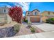 Charming two-story home featuring desert landscaping with brick walkway and mature landscaping at 2853 Blythswood Sq, Henderson, NV 89044