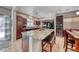Modern kitchen features a granite island, stainless steel appliances, and dark wood cabinets, perfect for entertaining at 2853 Blythswood Sq, Henderson, NV 89044