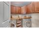 The laundry room features a front-load washer and dryer with wood cabinets at 2853 Blythswood Sq, Henderson, NV 89044