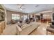 Open-concept living room with a ceiling fan, hardwood floors, and access to kitchen at 2853 Blythswood Sq, Henderson, NV 89044