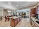 Bright, open-concept living space with a kitchen island, dining area, and cozy living room at 2853 Blythswood Sq, Henderson, NV 89044